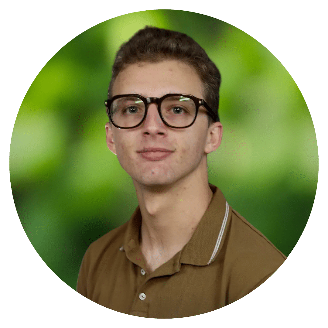 Circle cutout of Robert S' headshot behind a blurred green leaf background